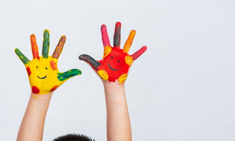 The hands of the child who smeared on the gray background.